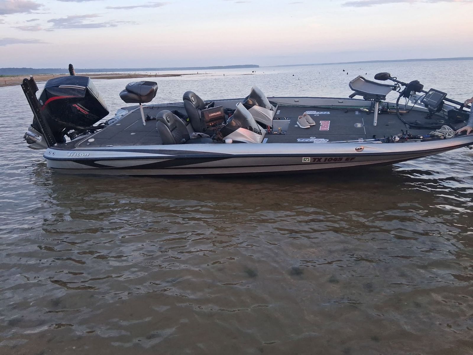 A TowBoatUS service boat stationed in shallow water with dual outboard motors and rescue equipment aboard.
