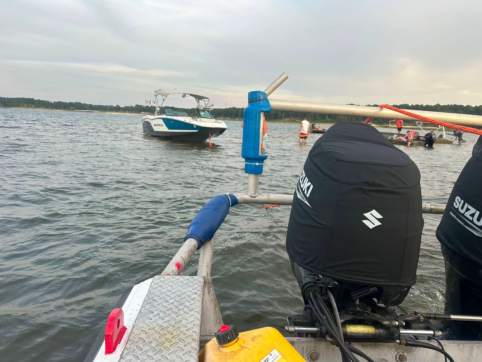 A TowBoatUS vessel moored on Sam Rayburn Reservoir beside a boat with outboard motors.