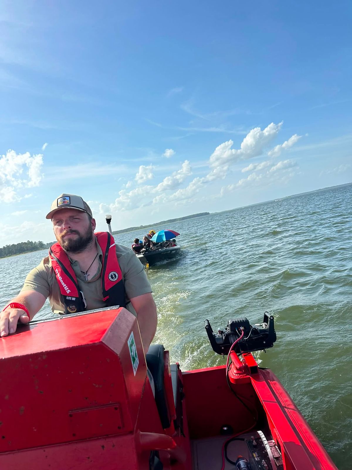 Mike Hogg at the helm of a red rescue boat on Sam Rayburn Reservoir.