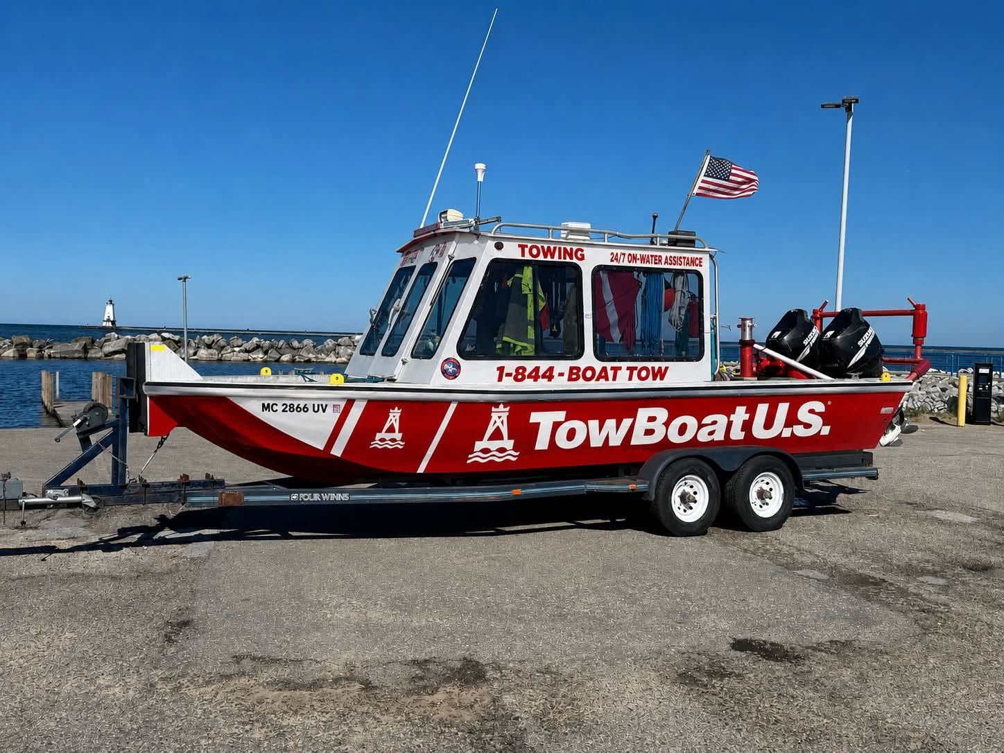 TowBoatUS Sam Rayburn's red and white towing vessel docked at the marina with the company name and (844) 262-8869 number on the hull.