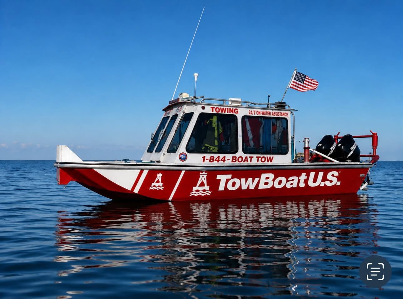 TowBoatUS Sam Rayburn towing vessel underway, the company name and (409) 332-5844 emergency number across its side.