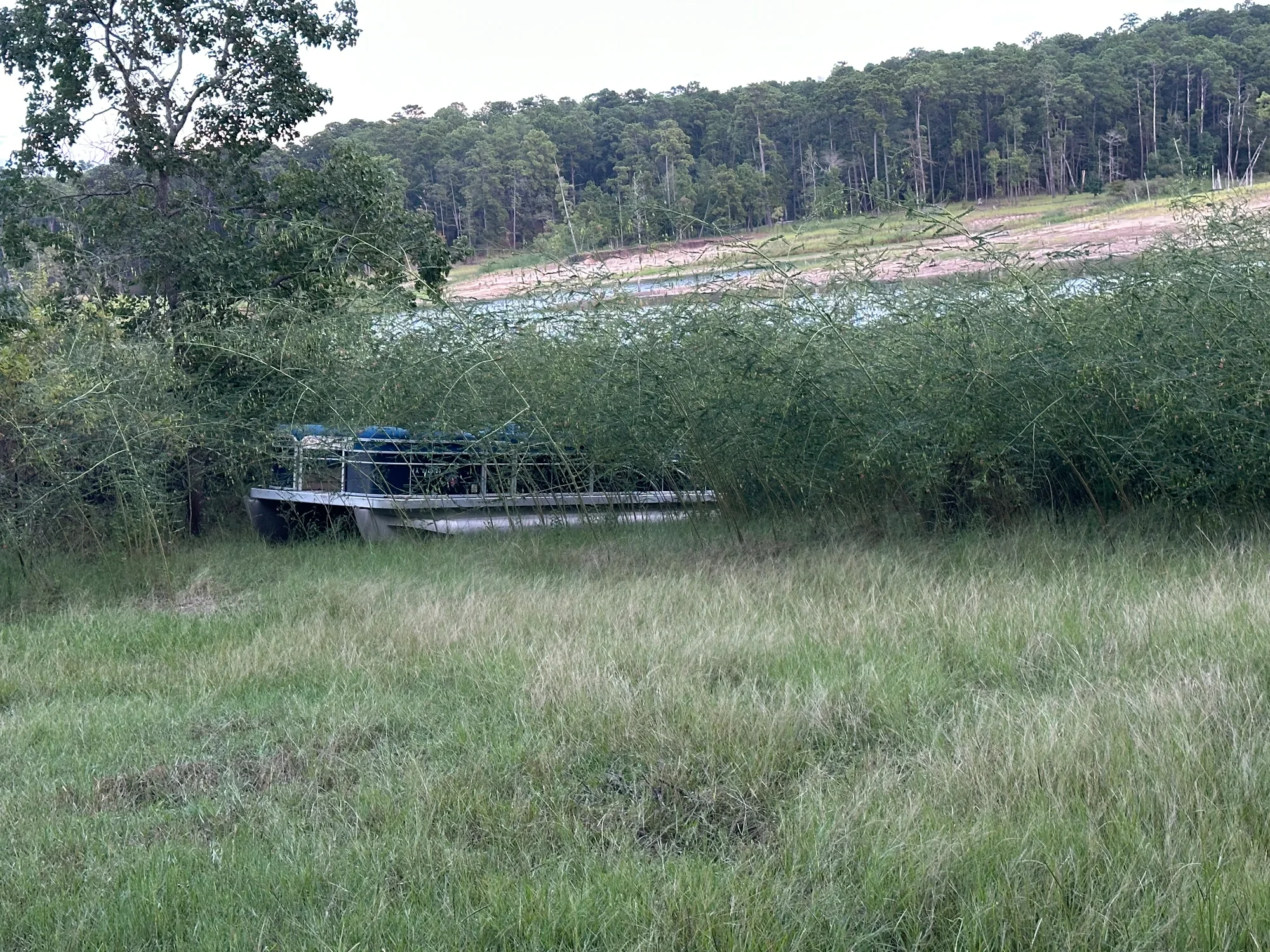 A pontoon boat stranded far up in the grass off Sam Rayburn, the shoreline and water stretching out behind it — a 300-foot recovery.